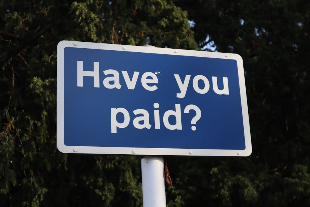A blue sign that says have you paid?