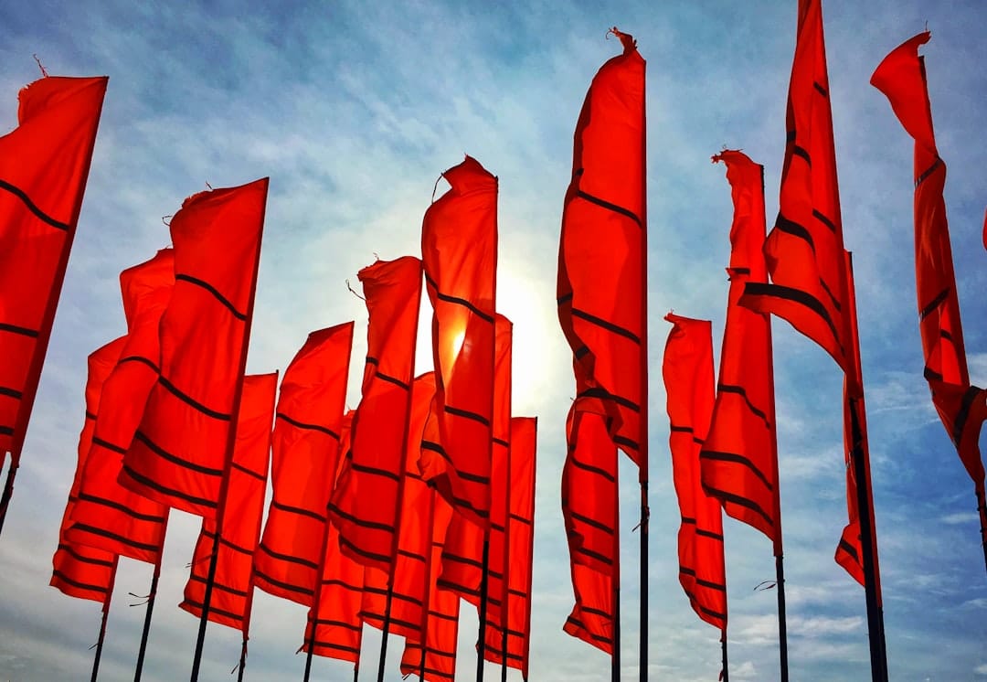 A bunch of red flags flying in the air