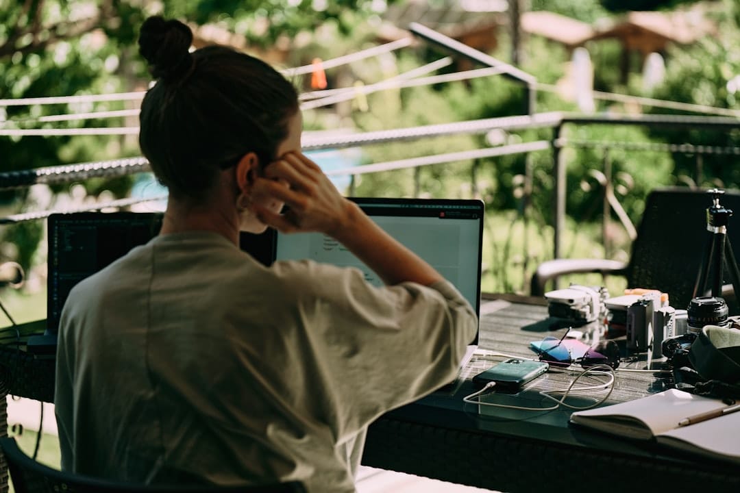 A woman sitting at a table with a laptop computer
